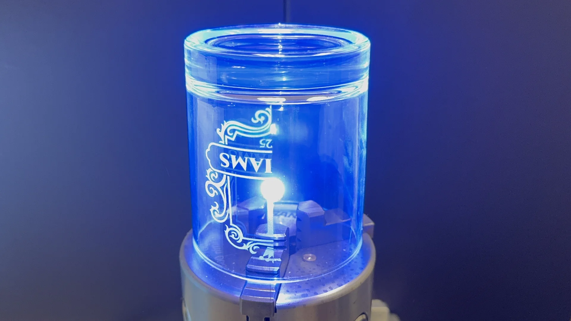 Laser engraving in progress on a decorated glass